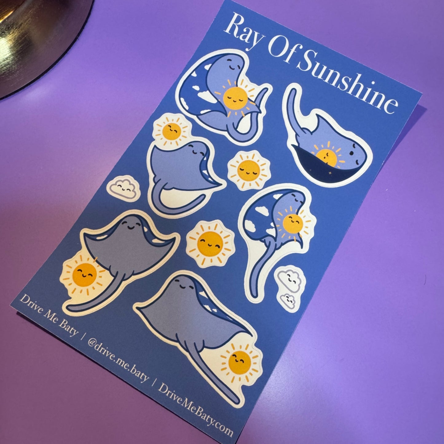 Sticker sheet with cartoon rays and suns on a purple background