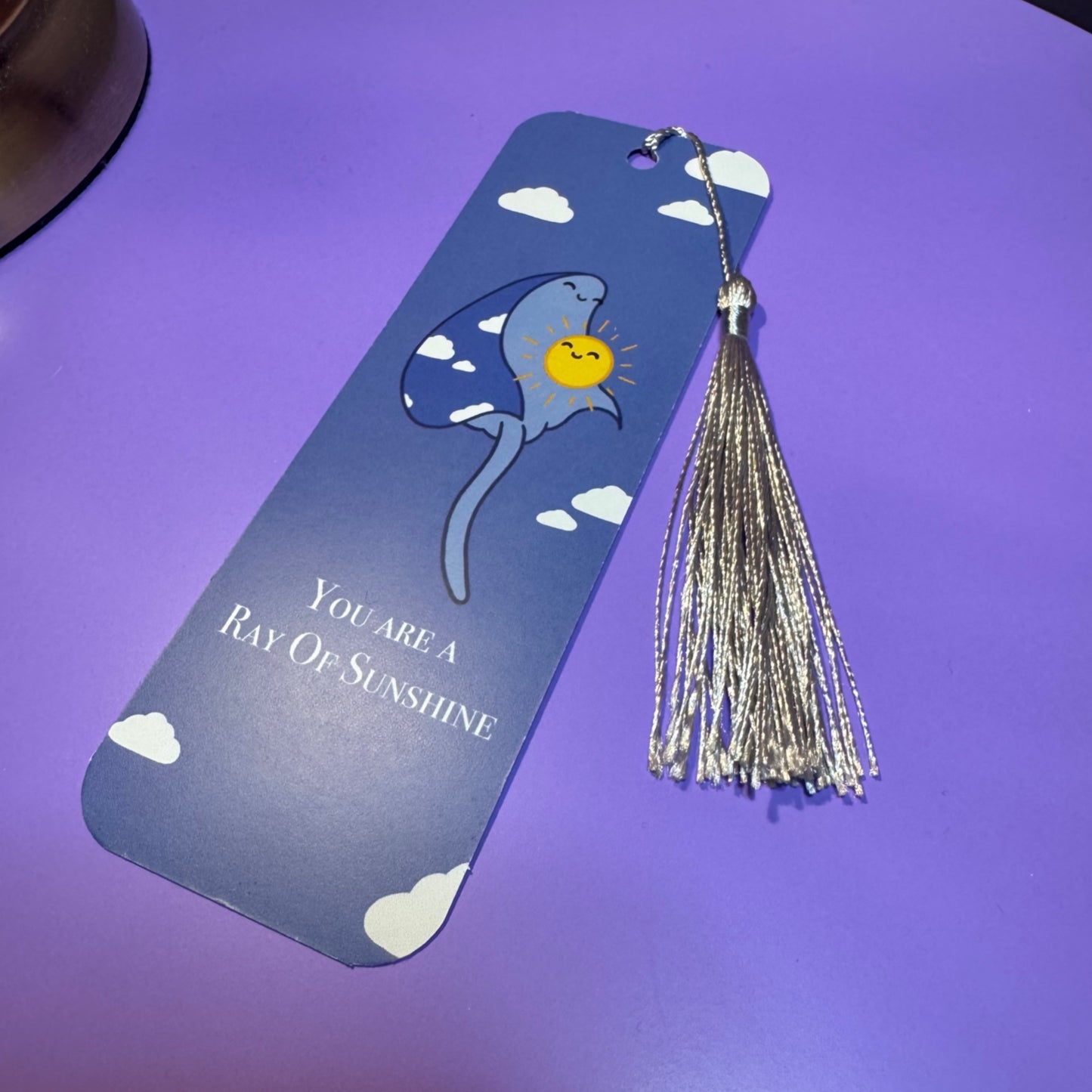 Bookmark with tassel on a purple background