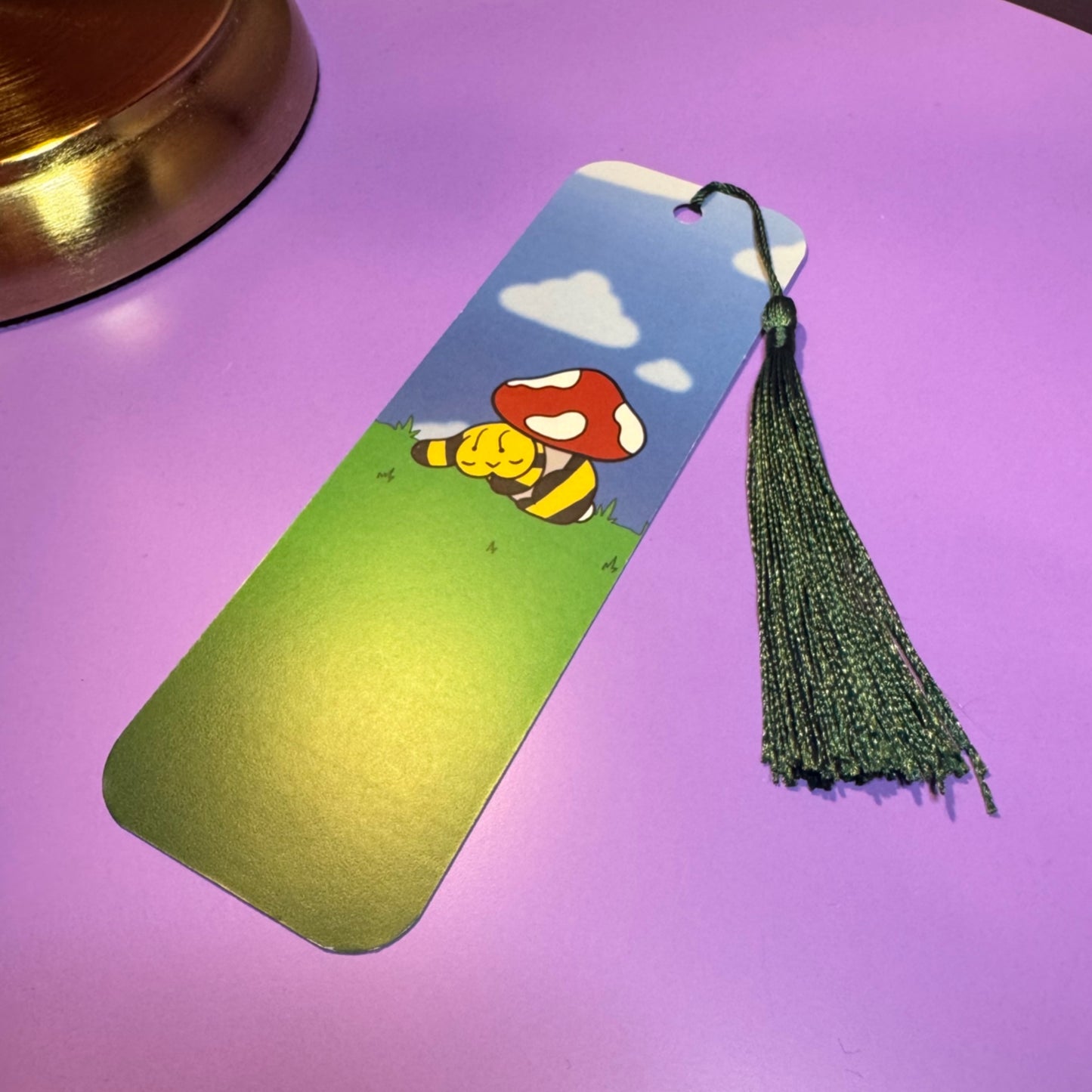 Bookmark with cartoon character and mushroom on a purple surface