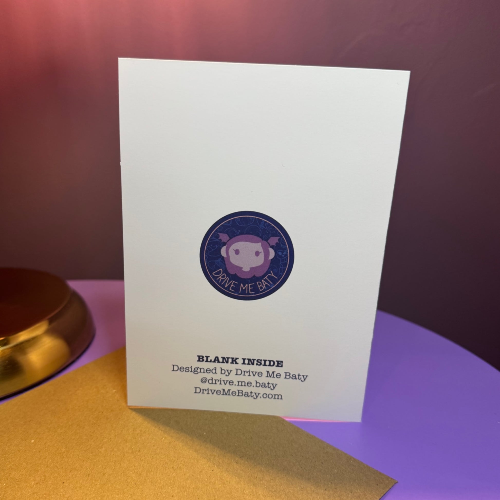 White card with a purple logo and text on a purple surface
