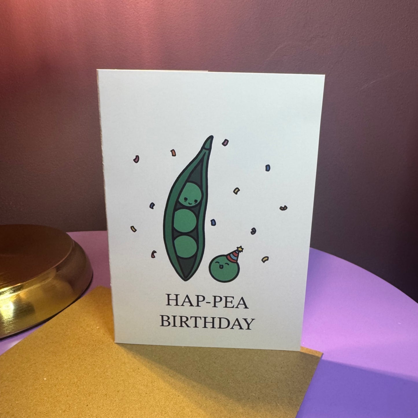 Birthday card with a green pea design and 'HAP-PEA BIRTHDAY' text on a purple background.